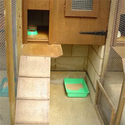 a green litter box sitting in the corner of a room